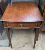 A reproduction mahogany Pembroke table with drop flaps and a frieze drawer on square tapering legs