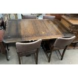 A 20th century oak extending dining table and four chairs