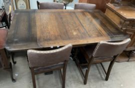 A 20th century oak extending dining table and four chairs