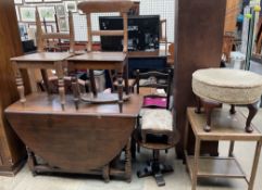 A 20th century oak gateleg dining table together with two dining chairs, two stools,