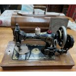 A Serata sewing machine in a walnut case