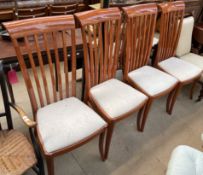 A set of four modern stick back dining chairs