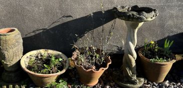 Terracotta planters together with a reconstituted urn and a bird bath