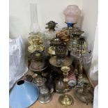 A collection of brass and glass oil lamps,