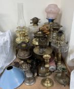 A collection of brass and glass oil lamps,