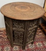 An Anglo Indian folding table carved with elephants and leaves