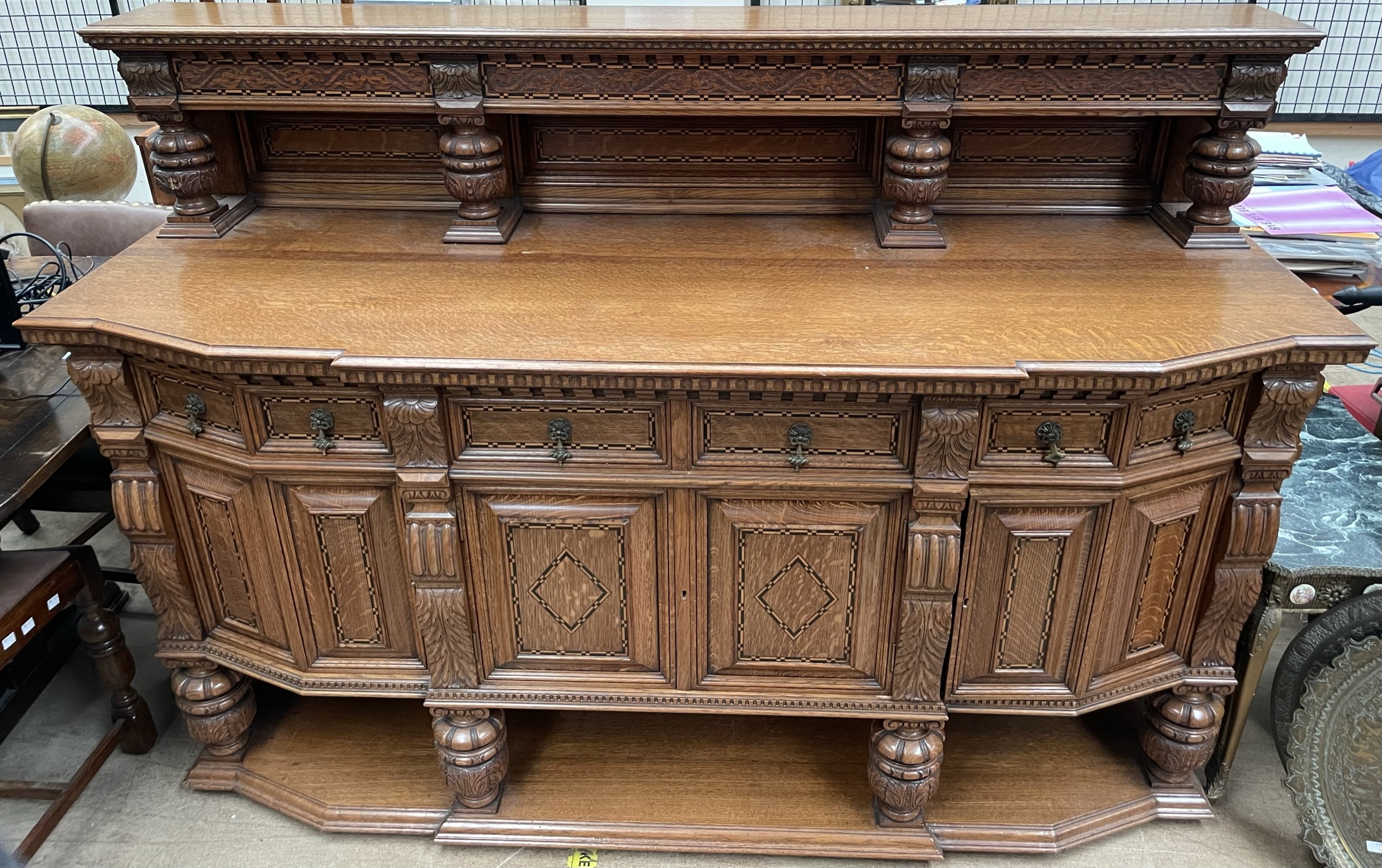 An Edwardian inlaid oak sideboard with a raised top,