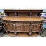 An Edwardian inlaid oak sideboard with a raised top,
