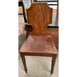 A Victorian mahogany hall chair with a shield shaped back on turned legs