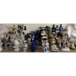 A collection of reproduction Staffordshire figures, together with other figure groups, toby jugs,