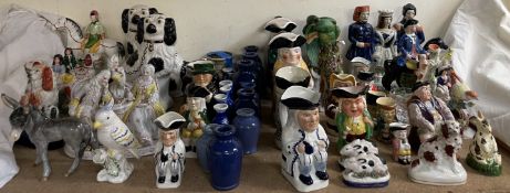 A collection of reproduction Staffordshire figures, together with other figure groups, toby jugs,