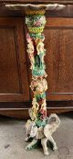 A faux ivory torchere, moulded with dragons,