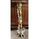 A faux ivory torchere, moulded with dragons,