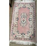 A pink ground Chinese rug together with a silk pile Kayam rug and two other Chinese rugs