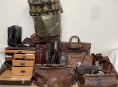 A leather covered travelling doctors bag together with a collection of leather bags, cases,