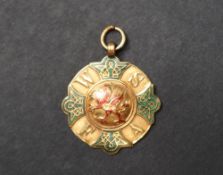 A 9ct yellow gold and enamel sporting medallion depicting a dragon and the initials WSFA,