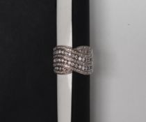 A diamond cross over band ring,