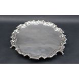 A George VI silver salver with "Chippendale" inspired edge, on three scrolling feet,