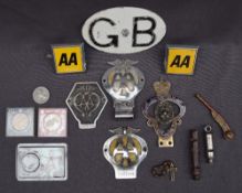 A collection of AA car badges together with a Royal British Legion car badge, commemorative coins,