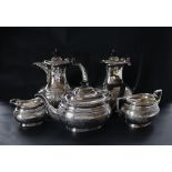 A George VI silver five piece tea and coffee service, with scrolling leaves engraved to the body,