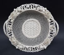 A Belleek wirework basket with three strand base and twin handles applied with roses,