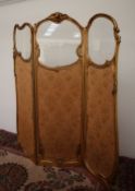 A French Gilt gesso three fold screen, carved with cherubs and leaves,