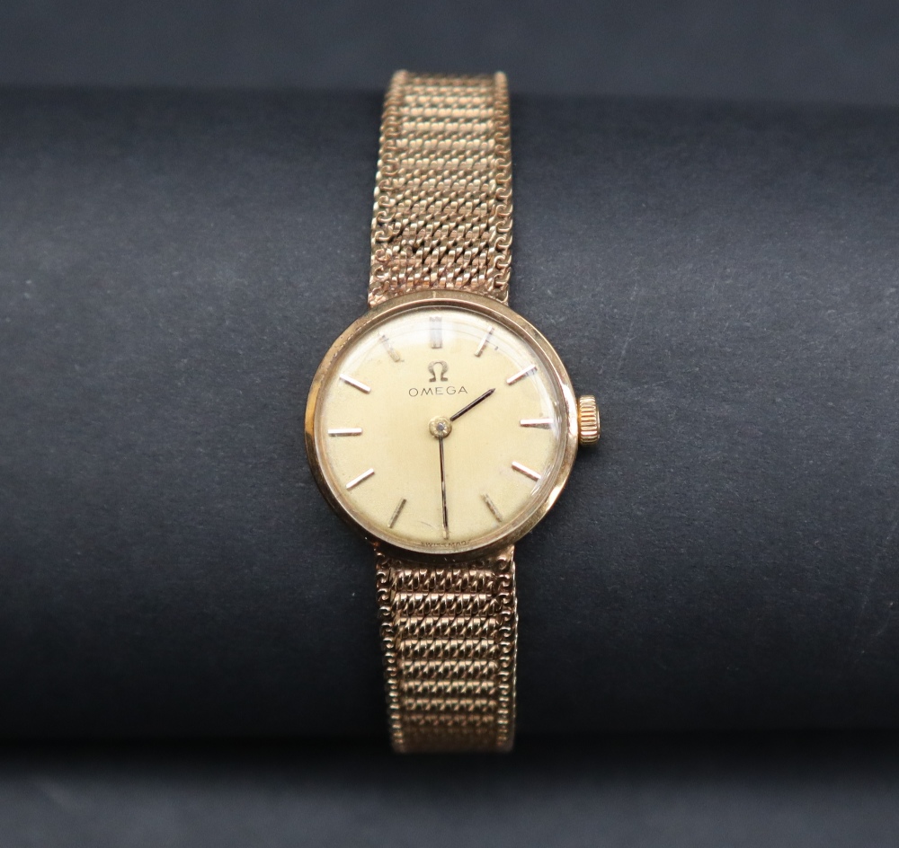 A lady's 9ct gold Omega wristwatch, the gilt dial with batons on an integral 9ct gold strap, - Image 2 of 6