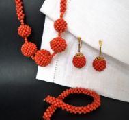 A suite of coral jewellery including a necklace, bracelet,