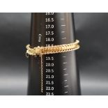 A yellow metal bracelet, with twisted oval and rectangular links, 20cm long,