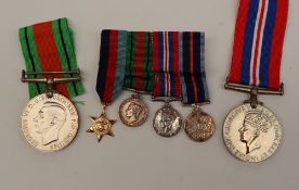 Two World War II medals including the War Medal and the Defence Medal together with a set of four
