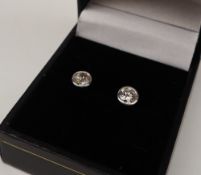 A pair of diamond stud earrings, the round brilliant cut diamonds each approximately 0.