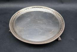 An Elizabeth II silver waiter, with a bed and husk border on three ball and claw feet, Sheffield,