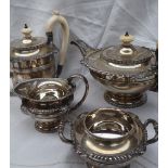 An Elizabeth II silver four piece tea set, comprising a flattened teapot, hot water jug, cream jug,