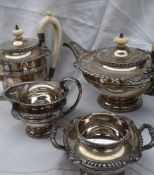 An Elizabeth II silver four piece tea set, comprising a flattened teapot, hot water jug, cream jug,
