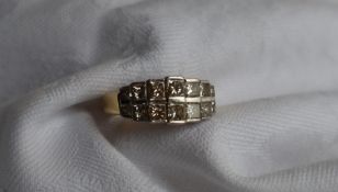 A diamond cluster ring, set with fourteen graduated princess cut diamonds, ranging from 3mm to 2.