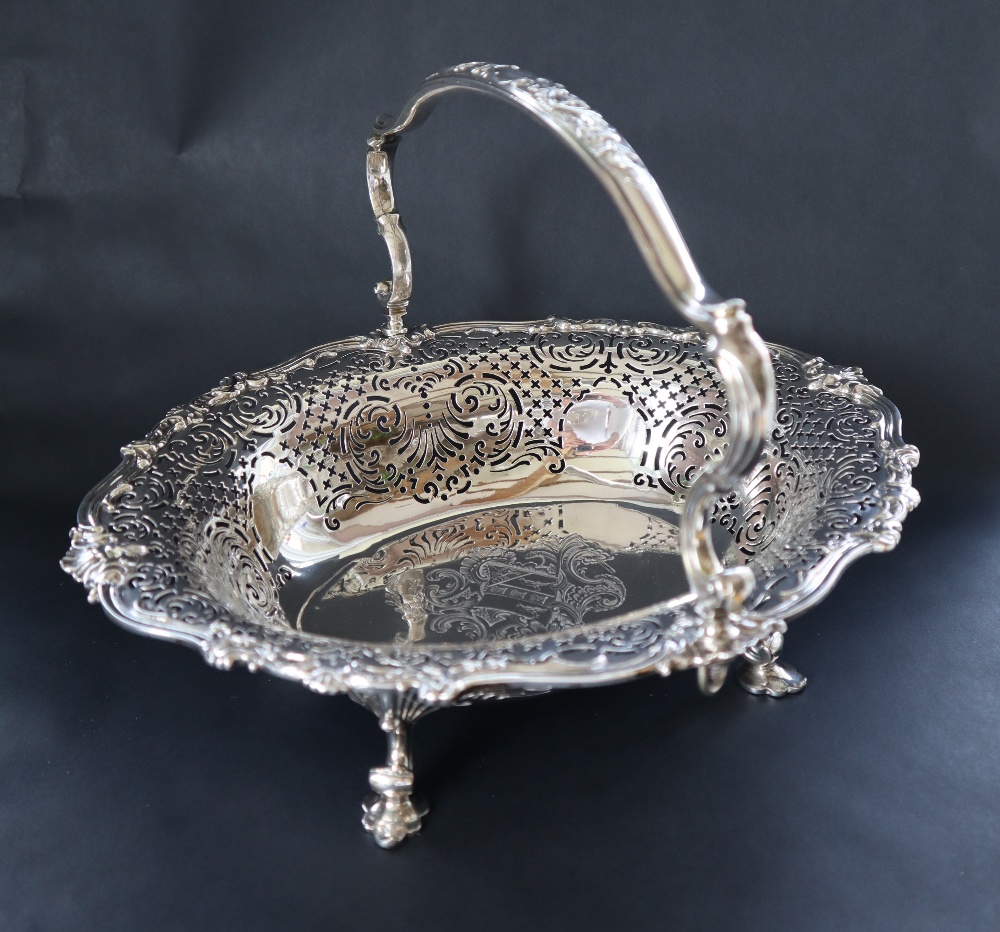 A George II silver cake basket, of pointed oval form, the border pierced with scrolls and leaves,
