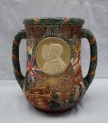 A Royal Doulton twin handled loving cup to celebrate the completion of 25 years reign of their