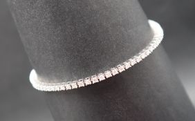 A diamond tennis bracelet set with seventy three round brilliant cut diamonds each approximately 2.