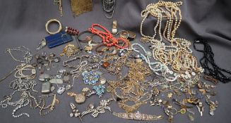 A large quantity of costume jewellery including necklaces, rings, brooches, bangles,