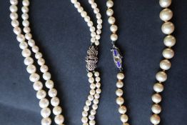 A double strand pearl necklace with graduated pearls, to a marcasite set clasp,