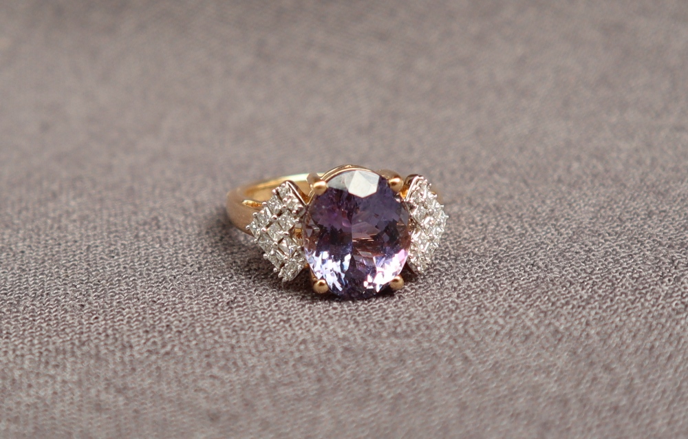 Gemporia - An 18ct gold tanzanite and diamond Lorique ring, set with an oval cut tanzanite,