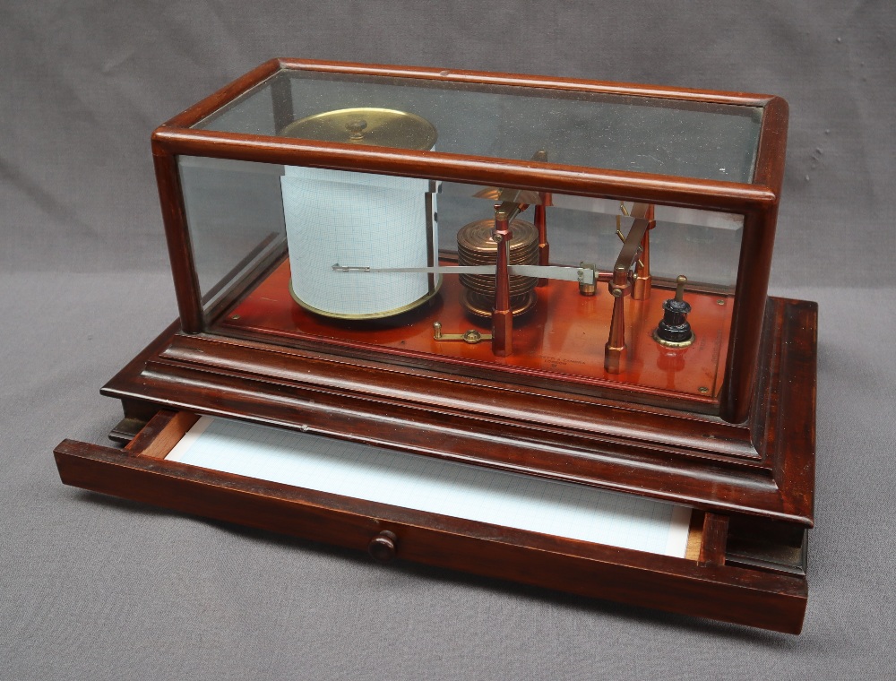 A Negretti and Zambra barograph, in a mahogany case with five bevelled glass panels,