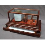 A Negretti and Zambra barograph, in a mahogany case with five bevelled glass panels,