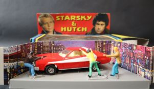 A 1977 Corgi Starsaky & Hutch Ford Torino, with three figures,