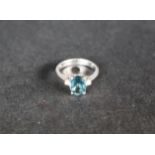 An 18ct white gold topaz and diamond ring,