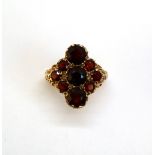 A 9ct yellow gold garnet cluster ring, set with nine round faceted garnets, approximately 5.