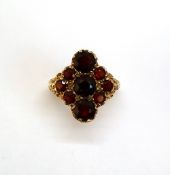 A 9ct yellow gold garnet cluster ring, set with nine round faceted garnets, approximately 5.