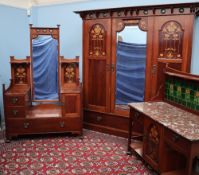 An Art Nouveau mahogany bedroom suite, possibly Liberty,