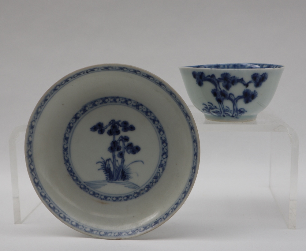 A Chinese Nanking Cargo blue and white porcelain tea bowl and saucer decorated with a tree and