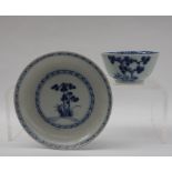 A Chinese Nanking Cargo blue and white porcelain tea bowl and saucer decorated with a tree and